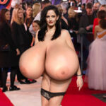 Ev.Gr. shows up naked at an event exposing her huge tits out