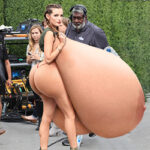 Skimpy babe Be.Th. exposing her giant tits and big butt out in public