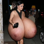 Ar.Wi. in a skimpy black dress exposing her huge tits at night
