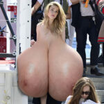Am.He. exposing her massive meaty tits in public
