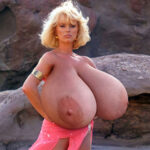 Sybil Danning in hot pink exposing her huge tits out