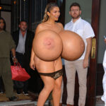 Ze. shows up naked exposing her huge tits in public